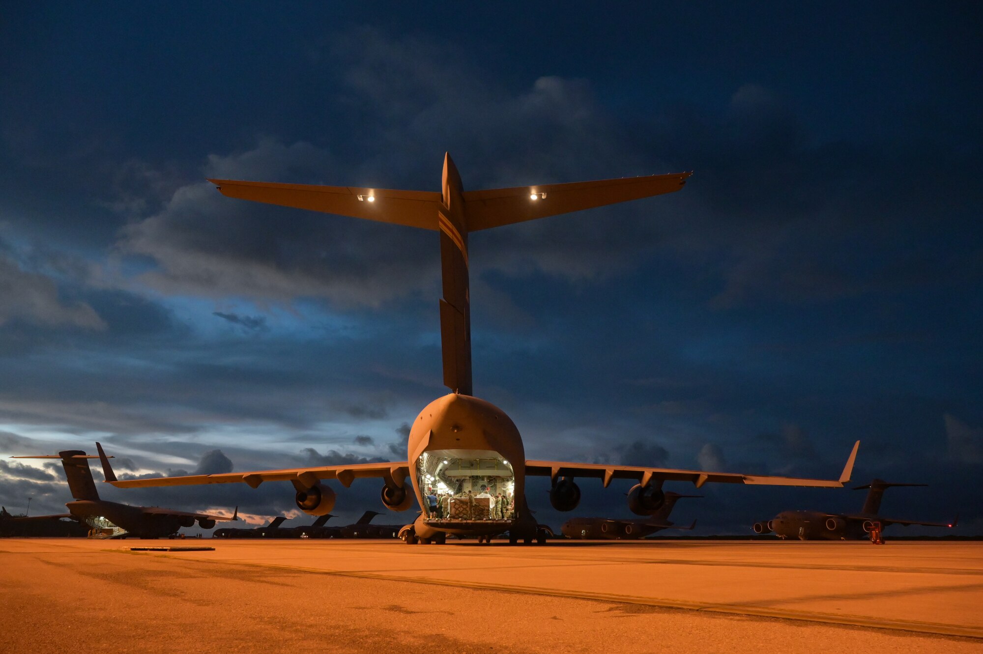 Eight U.S. Air Force C-17 Globemaster IIIs, assigned to Joint Base Pearl Harbor-Hickam, Hawaii, Joint Base Charleston, South Carolina, and Joint Base Elmendorf-Richardson, Alaska, stage on a flight line at Diego Garcia, British Indian Ocean Territory, Mar. 2, 2023, during Exercise Cobra Gold 2023. Cobra Gold, now in its 42nd year, is a Thai-U.S. co-sponsored training event that builds on the long-standing friendship between the two allied nations and brings together a robust multinational force to promote regional peace and security in support of a free and open Indo-Pacific. (U.S. Air Force photo by Staff Sgt. Alan Ricker)