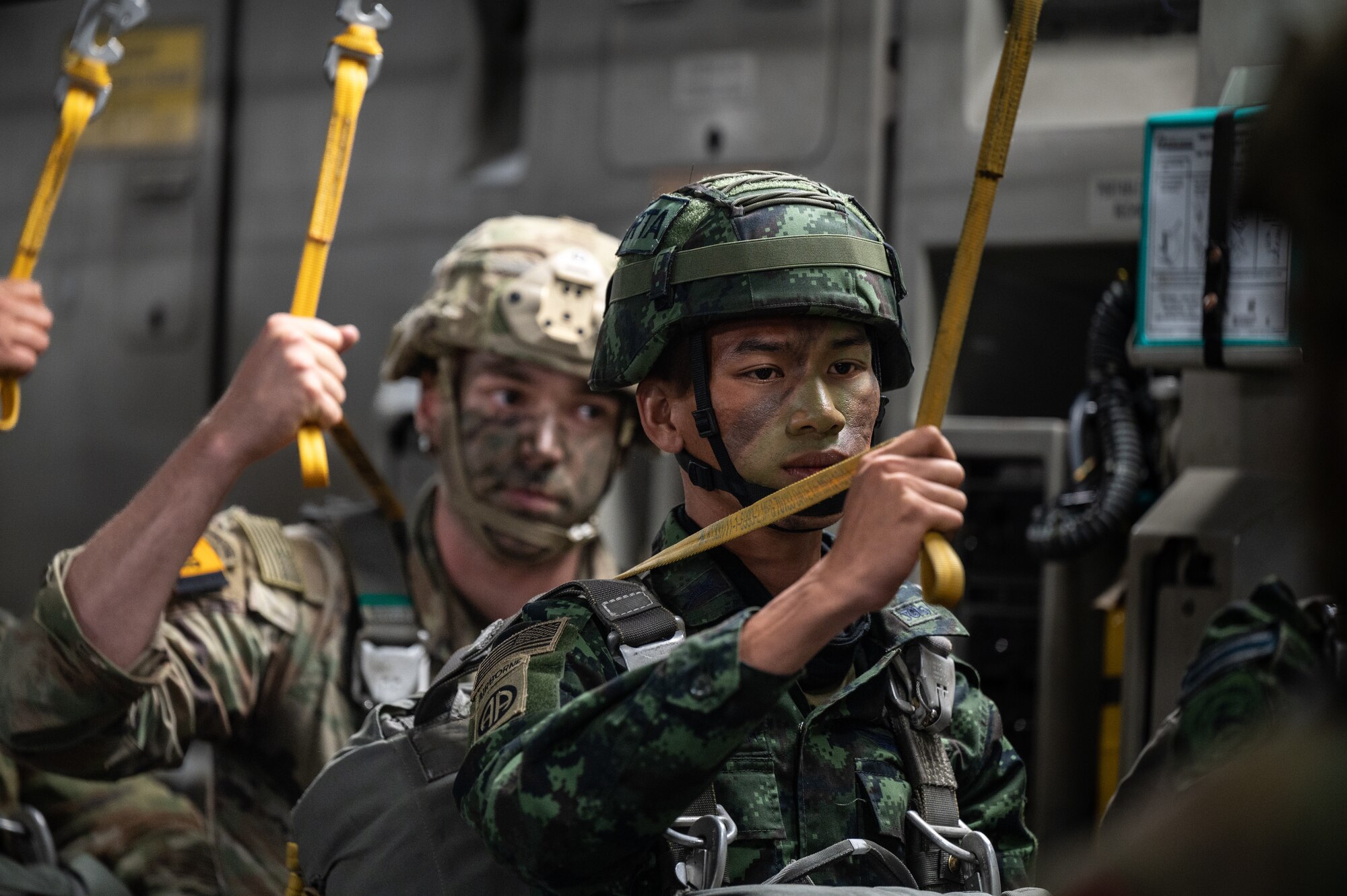 A Royal Thai Army soldier prepares to jump from a U.S. Air Force C-17 Globemaster III during Exercise Cobra Gold 2023 over the skies of the Kingdom of Thailand, Mar. 3, 2023. Cobra Gold, now in its 42nd year, is a Thai-U.S. co-sponsored training event that builds on the long-standing friendship between the two allied nations and brings together a robust multinational force to promote regional peace and security in support of a free and open Indo-Pacific. (U.S. Air Force photo by Staff Sgt. Alan Ricker)