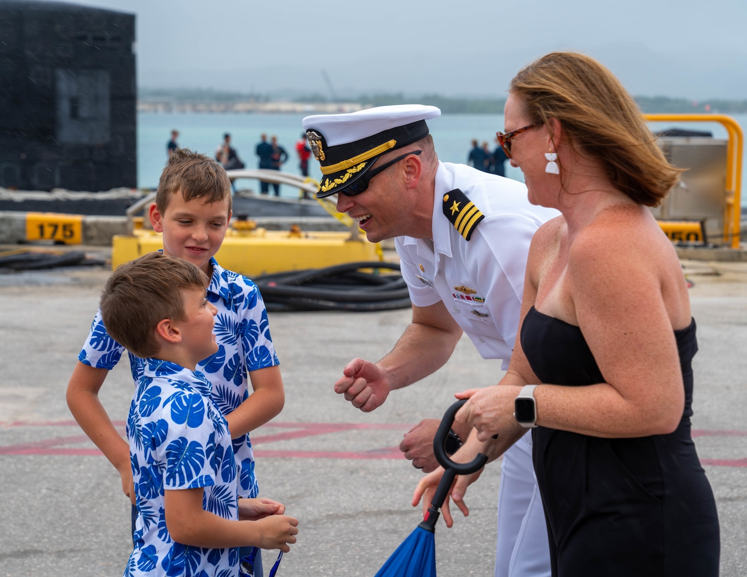 POLARIS POINT, Guam (Jan. 9, 2023) Cmdr. Andrew Domina, commanding officer of the Los Angeles-class fast-attack submarine USS Springfield (SSN 761),  greets his family after Springfield’s return to Guam from deployment, Jan. 9. Springfield is capable of supporting various missions, including anti-submarine warfare, anti-ship warfare, strike warfare and intelligence, surveillance reconnaissance. (U.S. Navy photo by Lt. Eric Uhden)