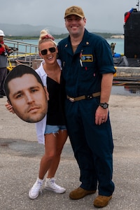 010923-N-DI326-003 POLARIS POINT, Guam (Jan. 9, 2023) Chief Machinist’s Mate (Auxiliary) Robert Lind and his family member pose for a photo after the Los Angeles-class fast-attack submarine USS Springfield (SSN 761) returns to Naval Base Guam, Jan. 9. Springfield is capable of supporting various missions, including anti-submarine warfare, anti-ship warfare, strike warfare and intelligence, surveillance reconnaissance. (U.S. Navy photo by Lt. Eric Uhden)