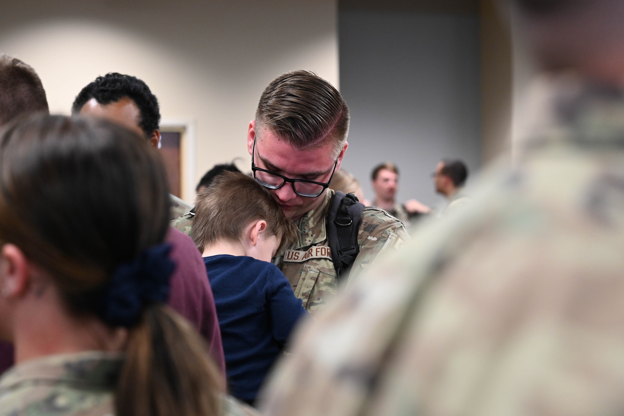 A U.S. Air Force service member reunites with family at Ellsworth Air Force Base, South Dakota, March 5, 2023, following a Bomber Task Force deployment to the Indo-Pacific region. BTF deployments support the National Defense Strategy tenets of deterring aggression and building a resilient Joint Force in the Indo-Pacific region. (U.S. Air Force photo by Airman 1st Class Dylan Maher)