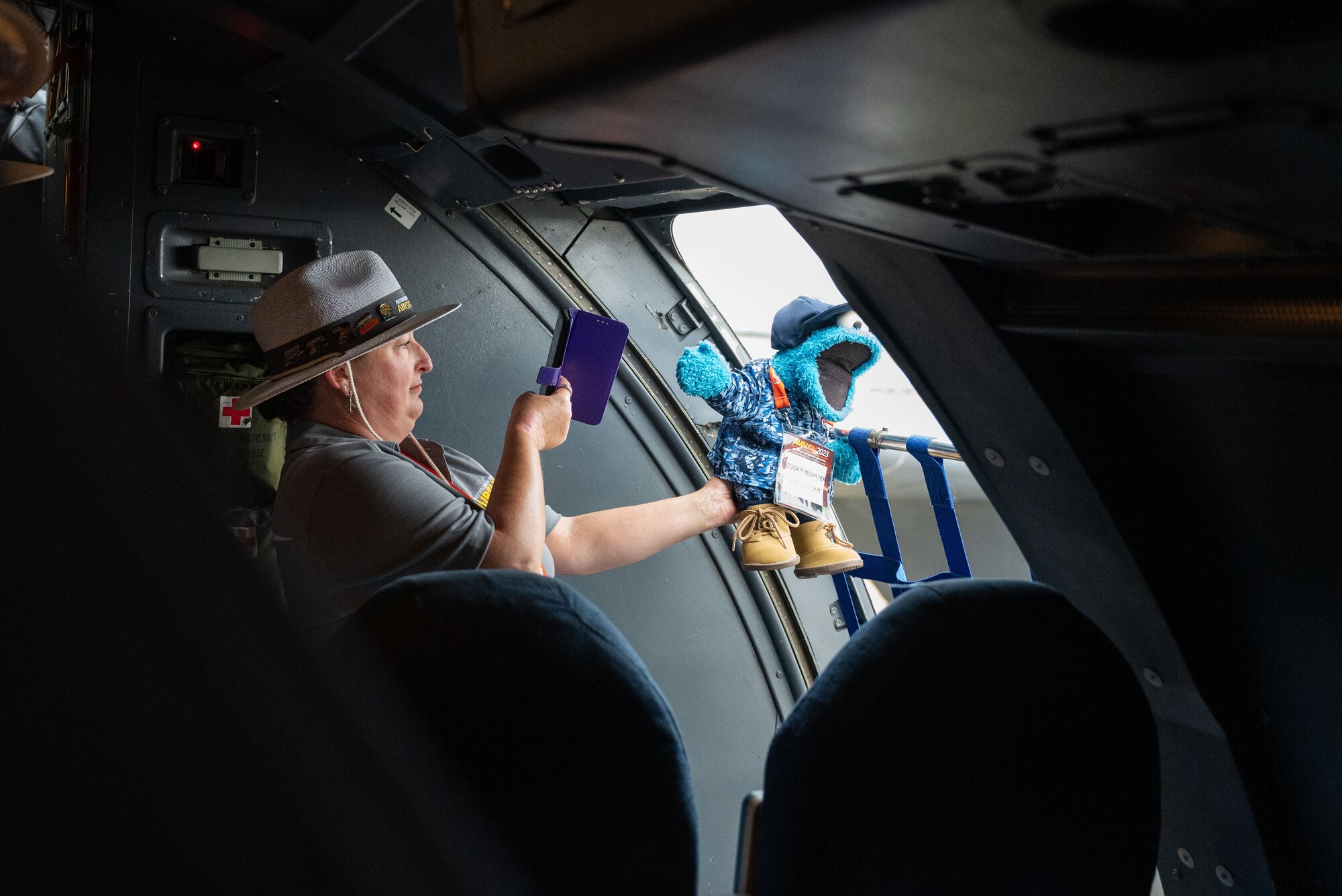 An event volunteer takes a photo of Cookie Monster—the event mascot—during a tour of the C-5 Galaxy during the 2023 Australian International Airshow and Aerospace & Defence Exposition—AVALON 23—at Avalon International Airport, March 1, 2023. AVALON 23 is the premier aerospace exhibition—airshow and tradeshow—in Australia and offers a venue to deepen our relationship with Australia and enhance regional security through expanded military-to-military cooperation with countries in the region. The C-5 Galaxy is a strategic transport aircraft and is the largest aircraft in the U.S. Air Force inventory. (U.S. Air Force photo by Tech. Sgt. Hailey Haux)