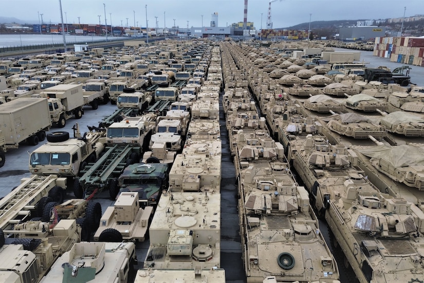 Military equipment sits on a loading dock.