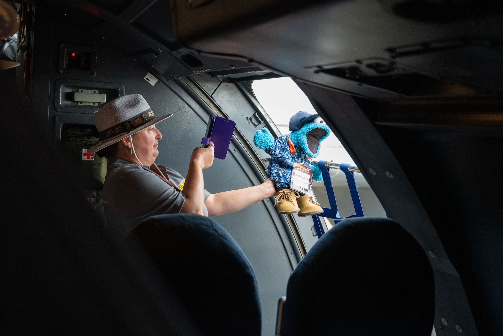 An event volunteer takes a photo of Cookie Monster—the event mascot—during a tour of the C-5 Galaxy during the 2023 Australian International Airshow and Aerospace & Defence Exposition—AVALON 23—at Avalon International Airport, March 1, 2023. AVALON 23 is the premier aerospace exhibition—airshow and tradeshow—in Australia and offers a venue to deepen our relationship with Australia and enhance regional security through expanded military-to-military cooperation with countries in the region. The C-5 Galaxy is a strategic transport aircraft and is the largest aircraft in the U.S. Air Force inventory. (U.S. Air Force photo by Tech. Sgt. Hailey Haux)