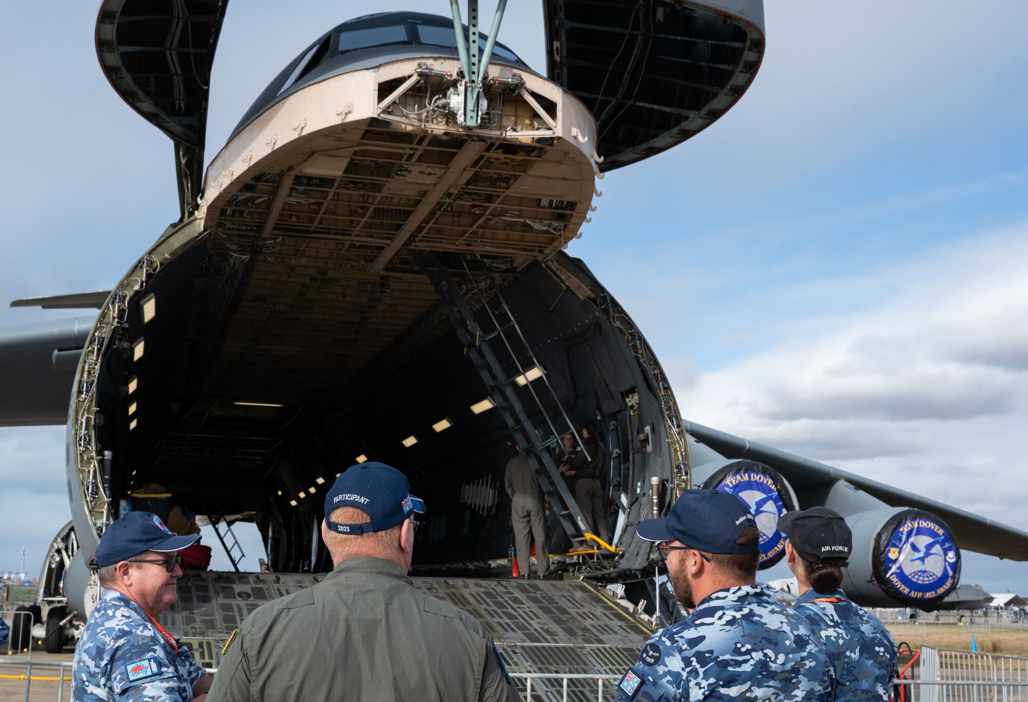 A U.S. Air Force C-5 Galaxy aircrew member talks to Australia Air Force members about the capabilities of the C-5 during the 2023 Australian International Airshow and Aerospace & Defence Exposition—AVALON 23—at Avalon International Airport, March 1, 2023. Our steadfast relationship with Australia, deeply rooted in our common principles and shared values, stems from working together day in and day out across the full spectrum of operations and will continue to prosper as we further integrate our efforts through events such as AVALON 23. The C-5 Galaxy is a strategic transport aircraft and is the largest aircraft in the U.S. Air Force inventory. (U.S. Air Force photo by Tech. Sgt. Hailey Haux)