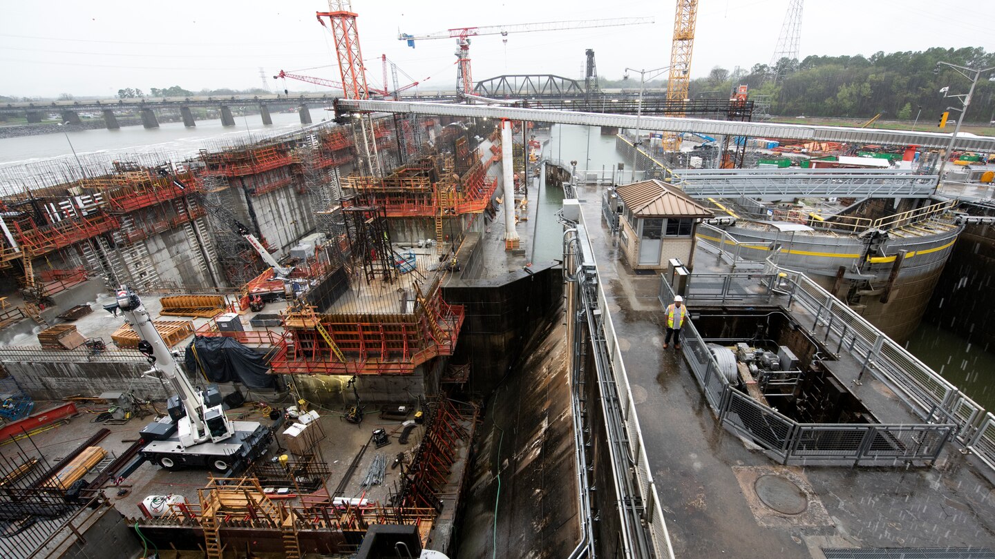Lock Operator Kenneth Hammock stands in between Chickamauga Lock and the replacement lock under construction March 2, 2023. He works to safeguard navigators at the active lock on the Tennessee River, which is very close to a U.S. Army Corps of Engineers Nashville District construction project to build a new 600-foot-long by 110-foot-wide lock. (USACE Photo by Lee Roberts)