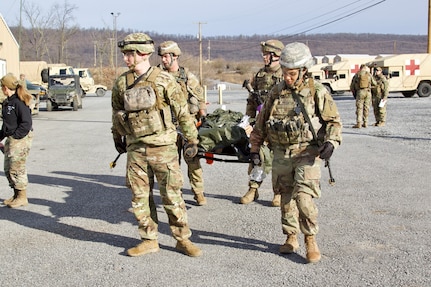 U.S. Soldiers carry a simulated casualty to a field hospital during an exercise at Fort Indiantown Gap, Pennsylvania, March 3, 2023. This exercise included responding to the scene of a mass casualty event, providing first aid and evacuating the simulated casualties to a field hospital while being assessed by instructors with the Pennsylvania National Guard’s 4th Battalion, 166th Regiment Regional Training Institute (Medical Battalion Training Site).