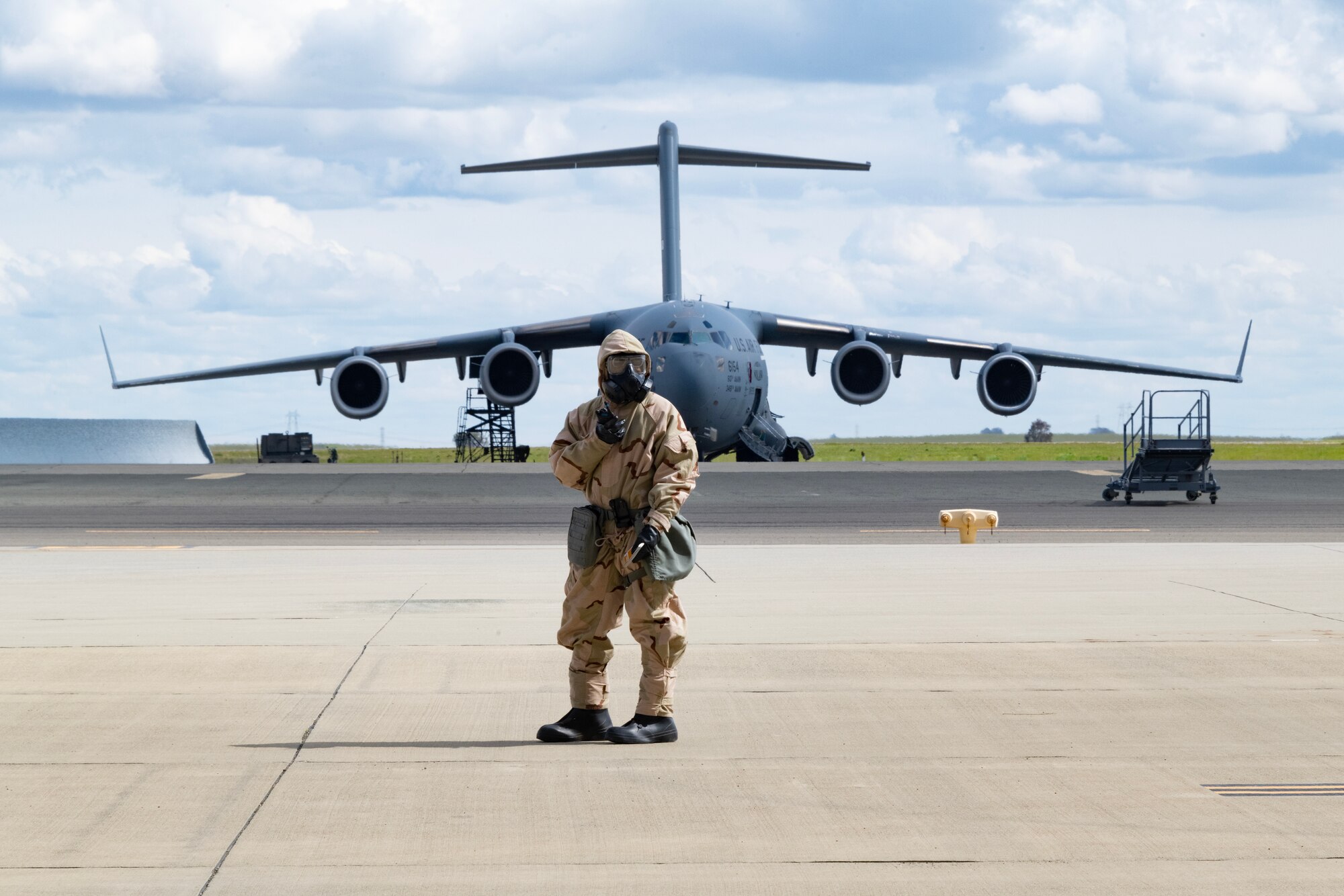 Airman stands in front of a C-17 Globemaster III aircraft