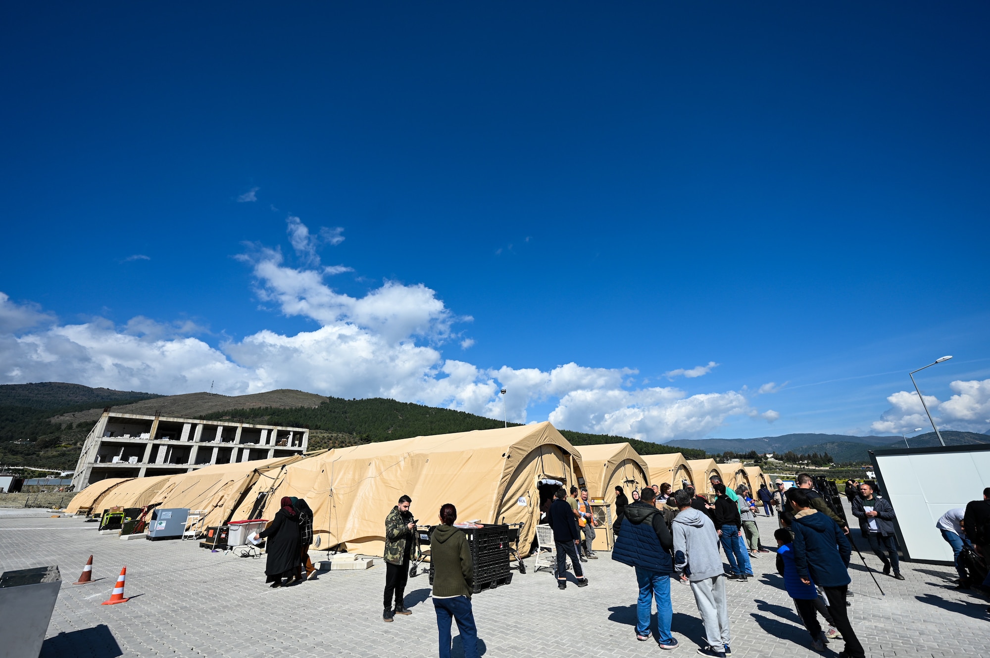 Patients and hospital personnel gather at the field hospital on the grounds of the Mustafa Kemal University in Serinyol, Hatay, Türkiye, March 7, 2023.