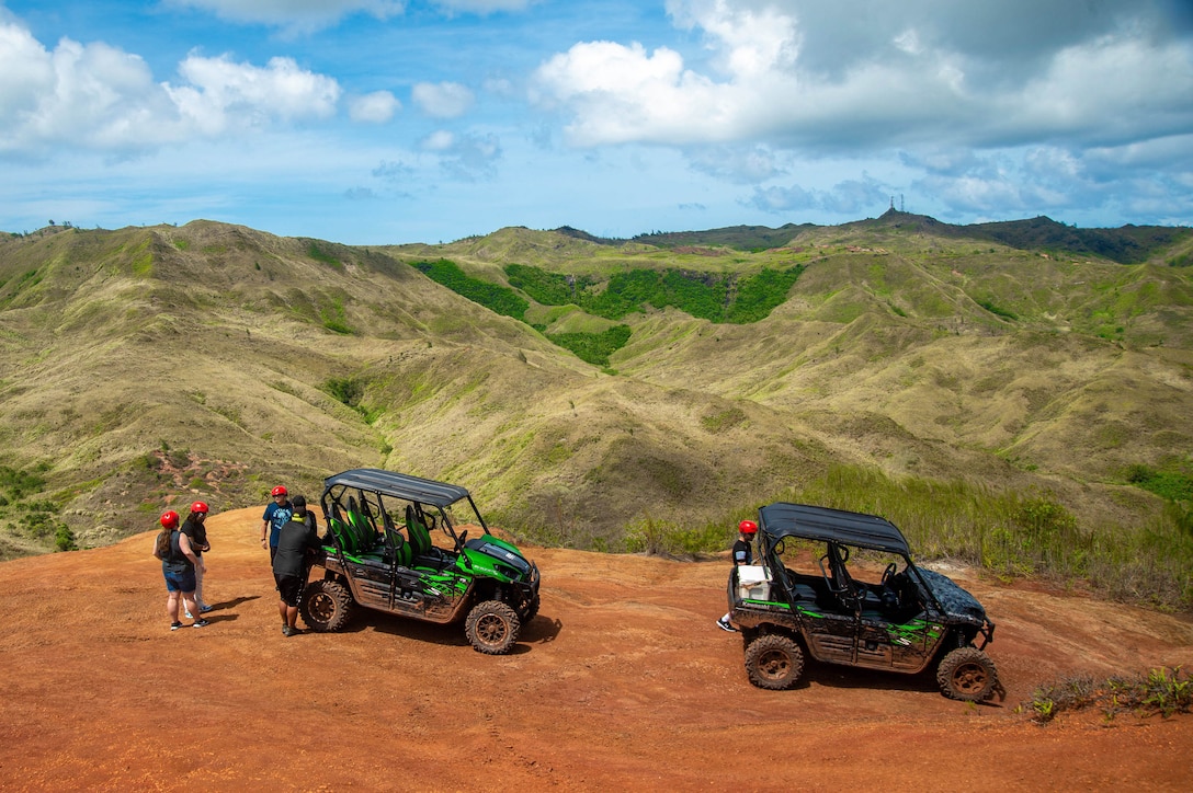 Sailors stand outside off-road vehicles during an excursion in Guam.