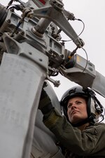 Naval Aircrewmen (Tactical Helicopter) 1st Class Krystal Stahl, a Sailor assigned to Helicopter Maritime Strike (HSM) 79 “Griffins” checks the tail rotor and fin during pre-flight checks flight in celebration of International Women’s Day on the flight line at Naval Station (NAVSTA) Rota, March 8, 2023.