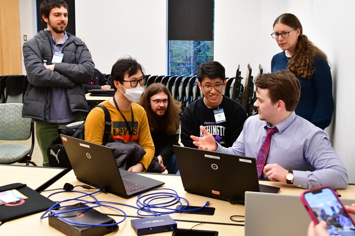 IMAGE: Students from William & Mary (W&M) listen intently to Brett Burcher, a Naval Surface Warfare Center Dahlgren Division engineer during judging at the Artificial and Machine Learning Innovation Challenge at Dahlgren, March 2. W&M placed third in the competition.