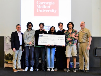 IMAGE: Carnegie Mellon University (CMU) took home first place honors during the Artificial Intelligence and Machine Learning Innovation Challenge at Dahlgren, March 2. The students were awarded a $50,000 cash prize for their efforts. Pictured from left to right: NSWCDD Technical Director Dale Sisson, SES, CMU team members Lucas Darcy, Austin Weltz, Medha Palavalli, Matthew Garcia, Pranav Rajbhandari and NSWCDD Commanding Officer, Capt. Philip Mlynarski.