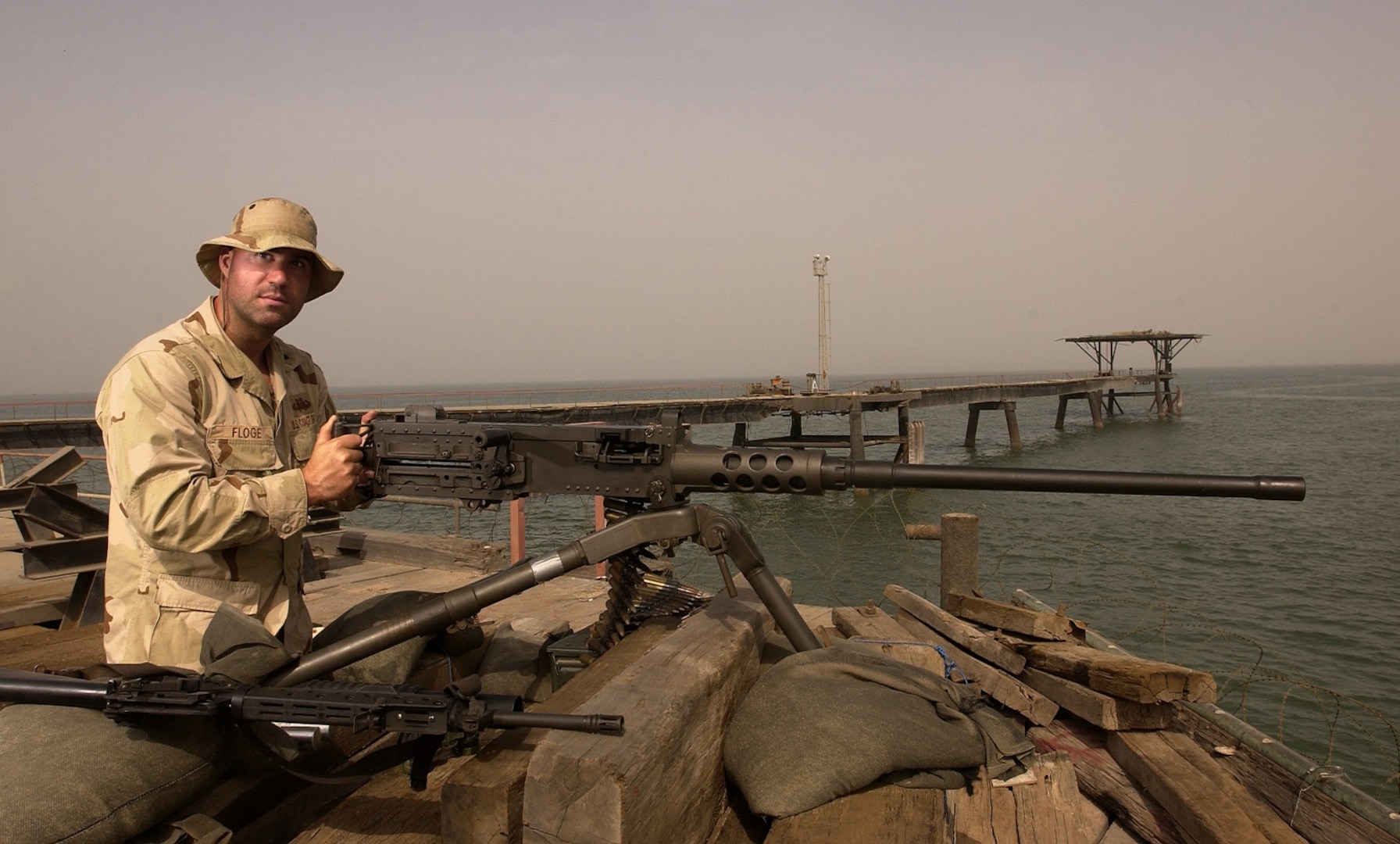Petty Officer Second Class Paul F. Floge, a Coast Guard reservist with Coast Guard Port Security Unit 311 out of San Pedro, Ca., provides security with a .50 caliber machinegun on the Khawr al Amaya oil terminal off the coast of Iraq.
Flodge, who works full time for the Los Angeles Police Department, is one of many reservists called to active duty in support of Operation Iraqi Freedom.