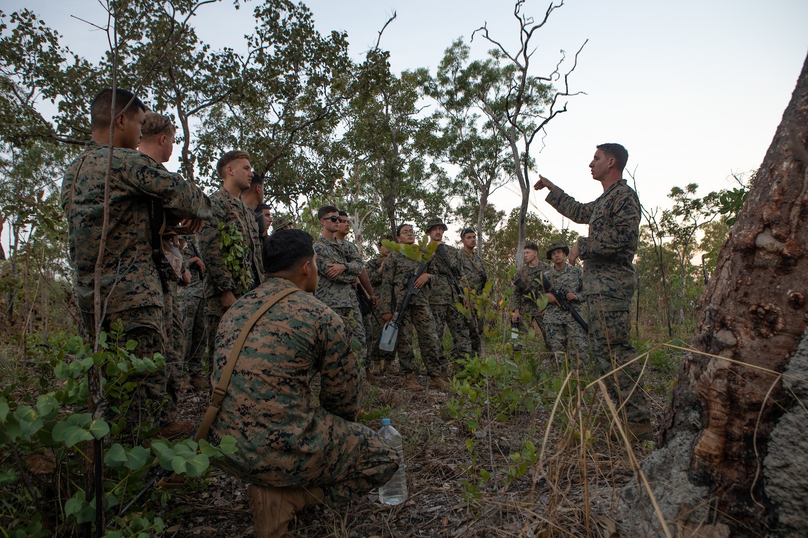 U.S. Marine Corps Gunnery Sgt. Joshua Owen, a motor transportation operations chief with Combat Logistics Battalion 7, Marine Rotational Force – Darwin, instructs Marines on different types of shelters during a wilderness survival training class at Mount Bundy Training Area, NT, Australia, June 5, 2021