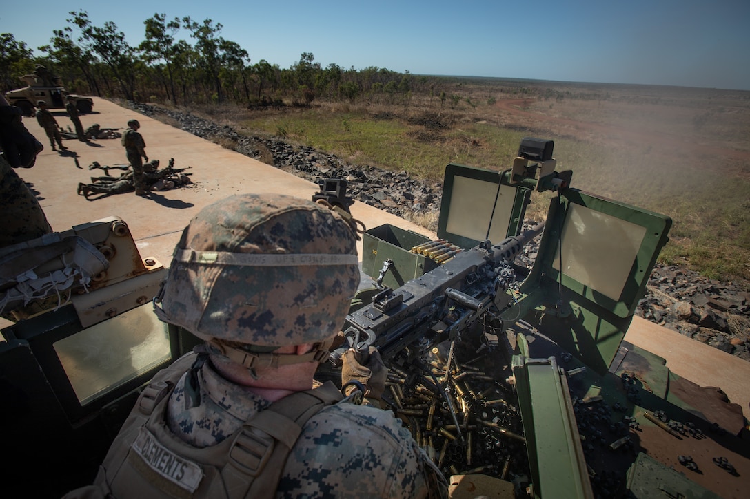 U.S. Marine Corps Cpl. Trevor Clements, a motor vehicle operator with Combat Logistics Battalion 7, Marine Rotational Force – Darwin, fires a mounted M2 heavy machine gun during a live fire range at Mount Bundey Training Area, NT, Australia, June 7, 2021.