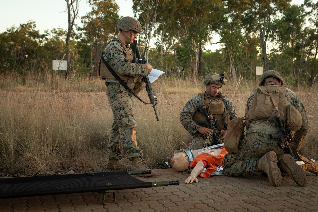 U.S. Marines with Combat Logistics Battalion 7, Marine Rotational Force - Darwin and a U.S. Sailor with MRF-D provide simulated medical care to a casualty dummy before a live fire range at Mount Bundey Training Area, NT, Australia, June 7, 2021. Before the range, Marines and a Sailor practiced emergency medical care and evacuation of a seriously injured person to be ready for any incident that may occur in the field. The training hones the Marines’ capabilities as a skilled expeditionary fighting force that is capable of responding to a potential crisis or contingency. (U.S. Marine Corps photo by Sgt. Micha Pierce)
