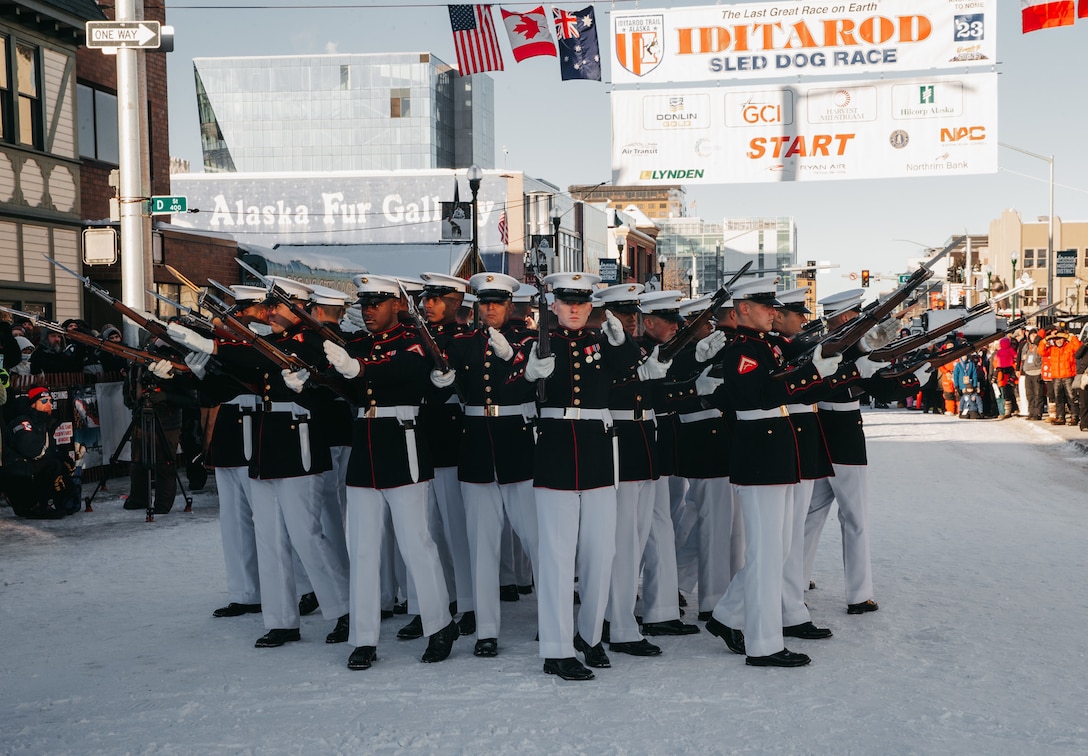 The Silent Drill Platoon performs for the ceremonial opening of the annual Iditarod in Anchorage, Alaska, on March 4, 2023. The visit is part of a joint effort between Marine Barracks Washington and Marine Corps Recruiting Command designed to increase awareness of the Marine Corps and prepare the unit for the upcoming summer parade season at Marine Barracks Washington, D.C., the oldest post in the Marine Corps. (United States Marine Corps photo by SSgt. Sarah Ralph)