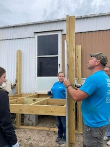 IMAGE: Janna Roland and her husband, Tommy Roland, install a handicap ramp during a 516 Project Panama City, a Christian based 501c3 non-profit construction ministry. The Rolands started the project Panama City, Florida, in collaboration with the Fredericksburg project. Janna Roland is the Test Execution Lead for the USS SECURE Team at Naval Surface Warfare Center Dahlgren Division (NSWCDD). She is recognized as a NSWCDD Distinguished Community Service Award recipient.