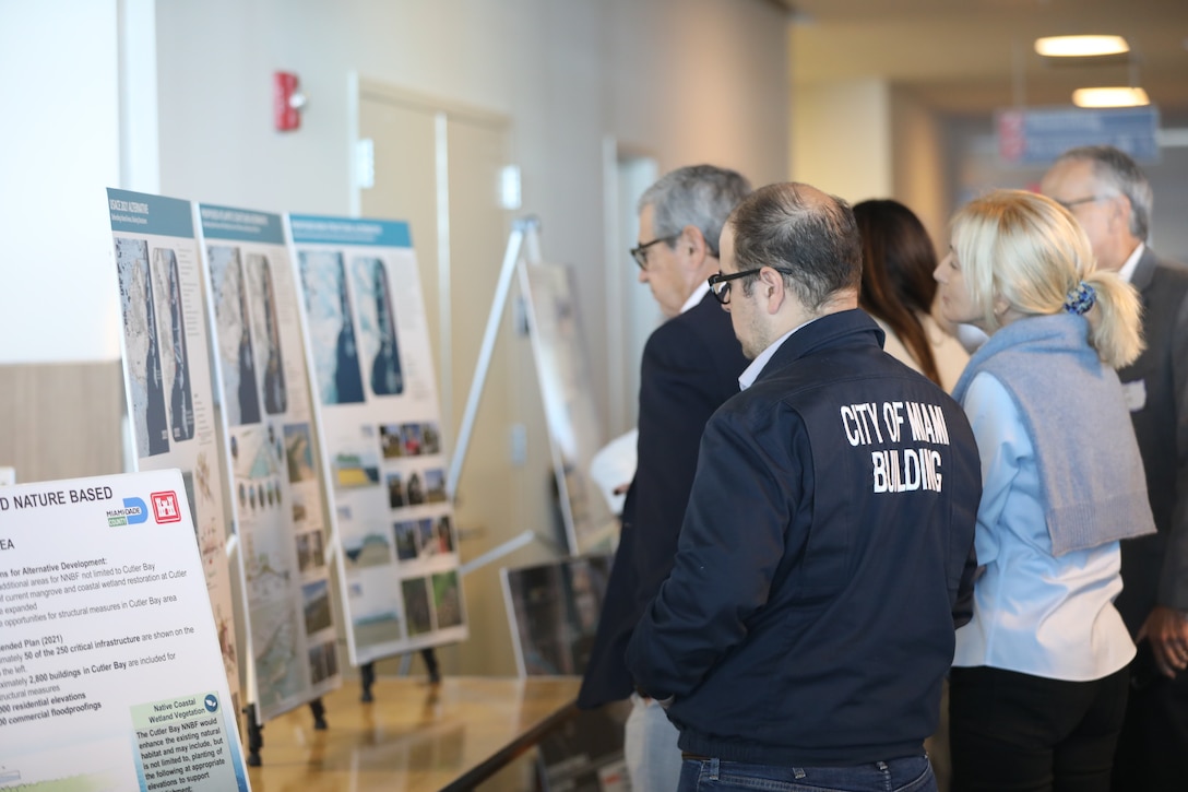 Stakeholders gather around posterboards that display the proposed alternatives for the re-initiation of Miami-Dade Back Bay Coastal Storm Risk Management Study during the charrette hosted by Miami-Dade County and The U.S. Army Corps of Engineers on March 1. Photo by Breeana Harris, USACE Norfolk District.