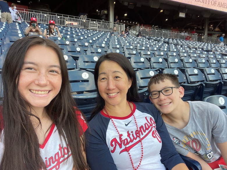 Col. Mia Walsh, SBD 3, commander, center, is joined by her children at a Washington Nationals baseball game.