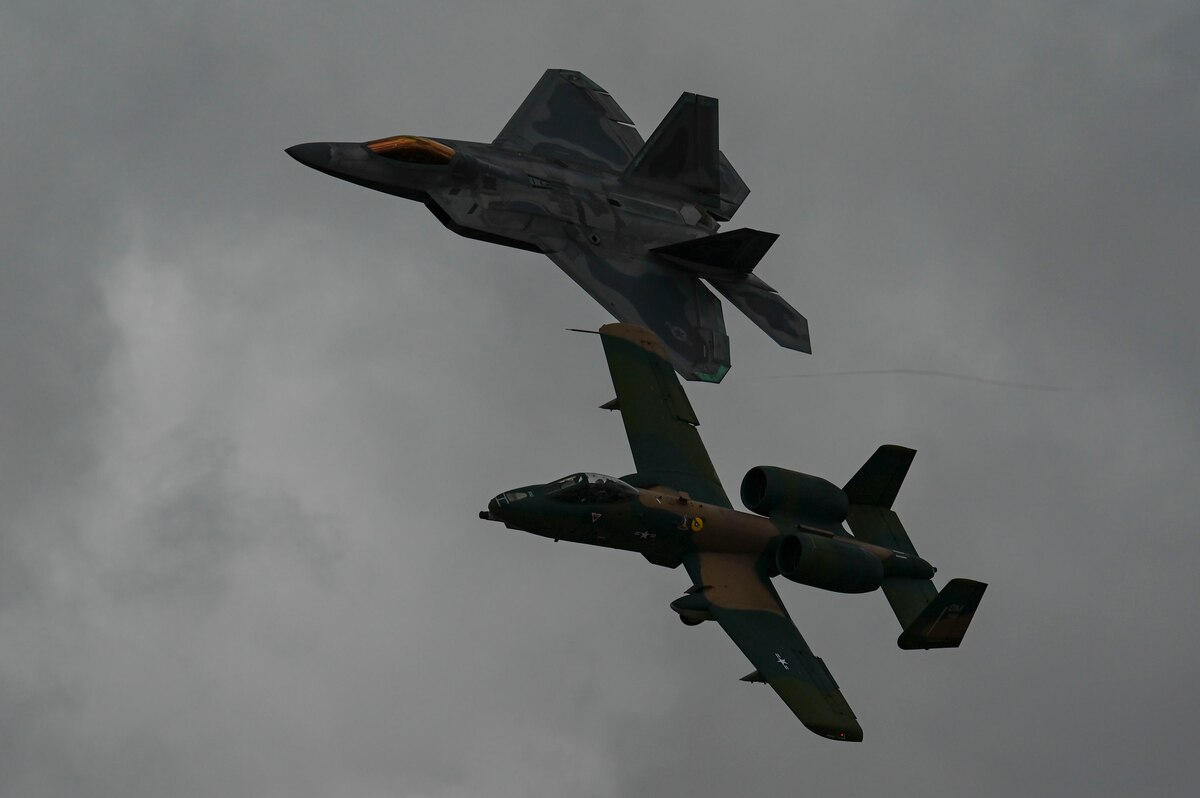 A photo of two aircraft flying in a formation.
