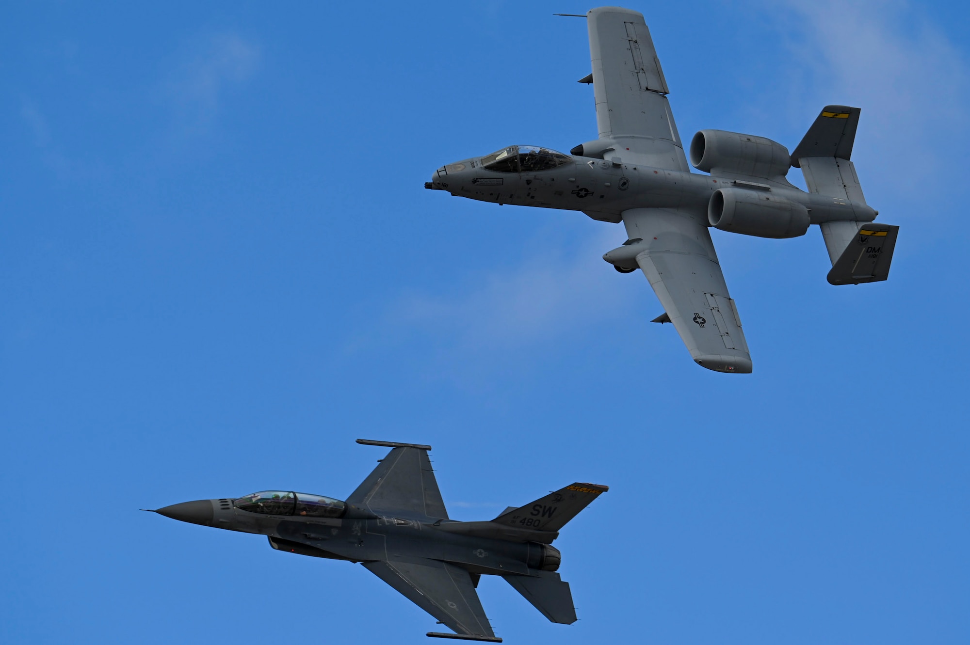 A photo of two aircraft flying in a formation.
