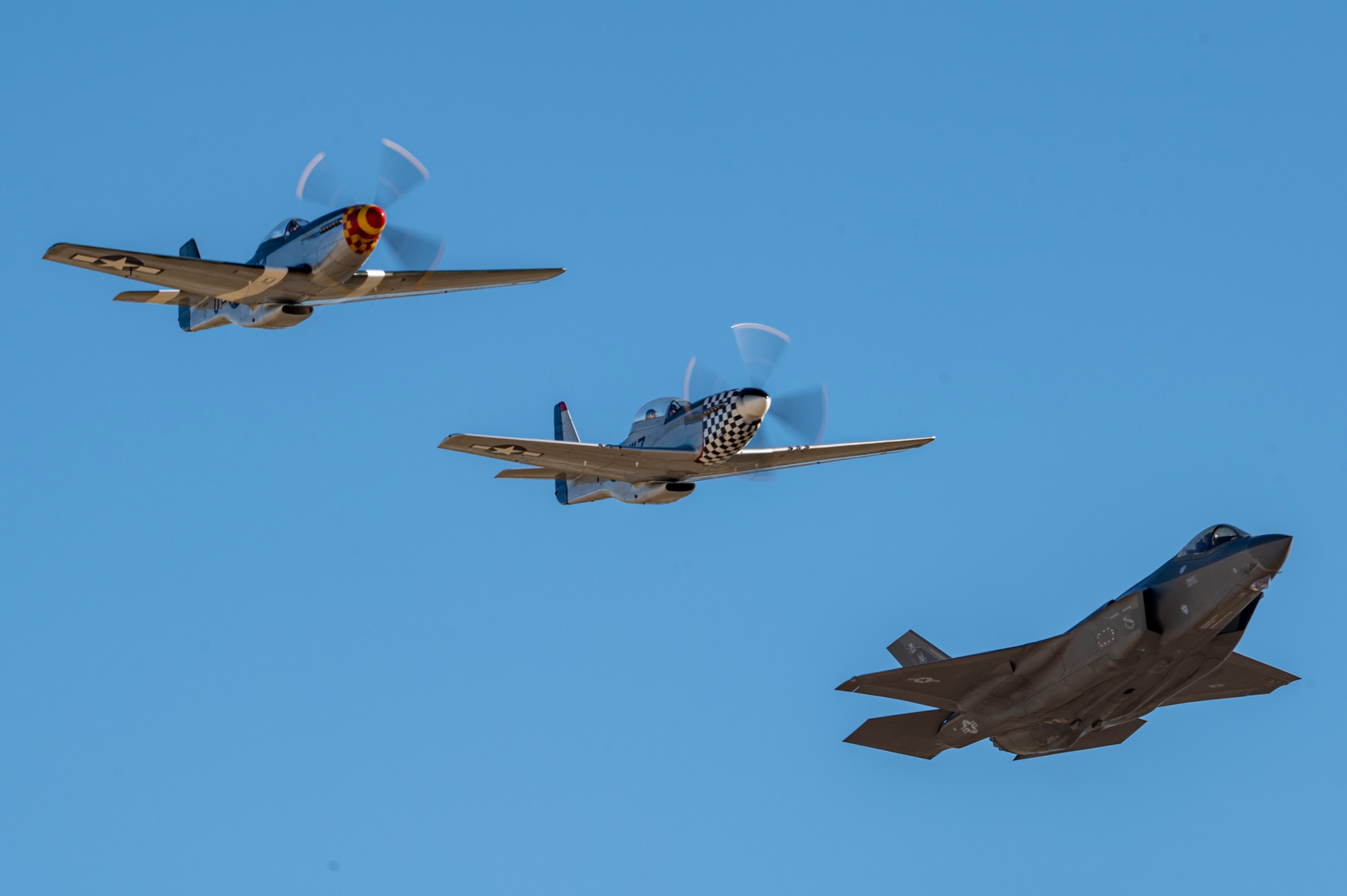 A photo of three aircraft flying in a formation.