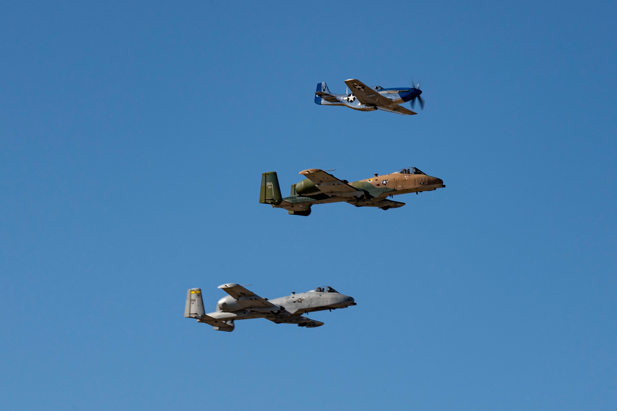 A photo of three aircraft flying in a formation.