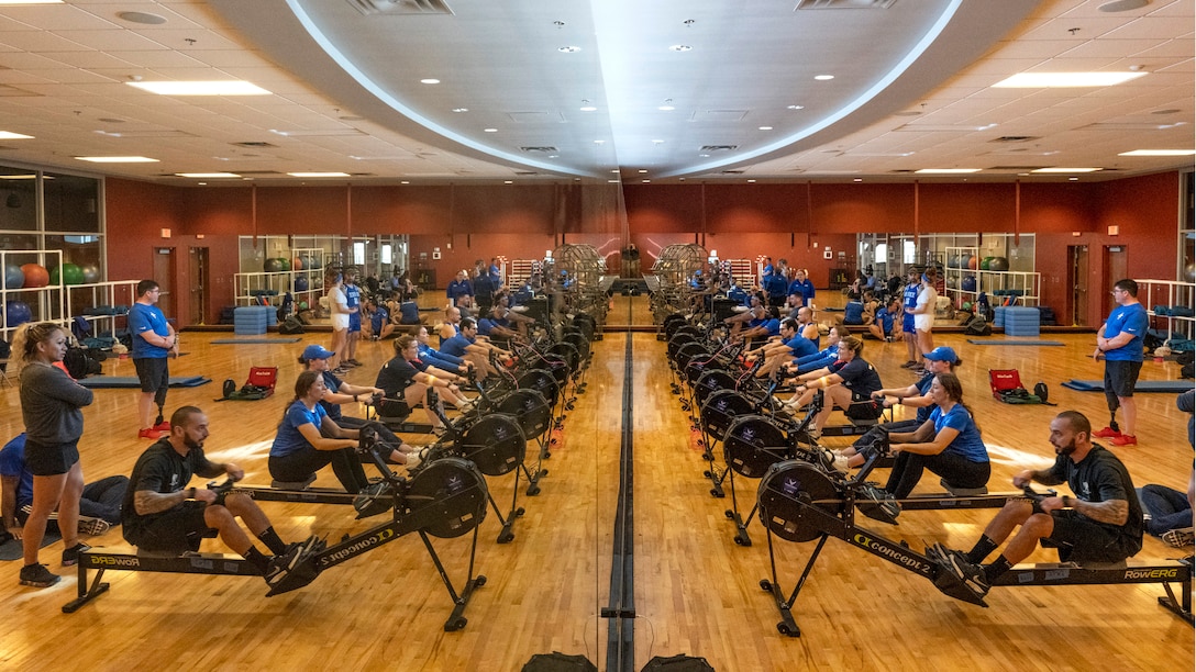 Athletes are seen symmetrically mirrored while practicing rowing.