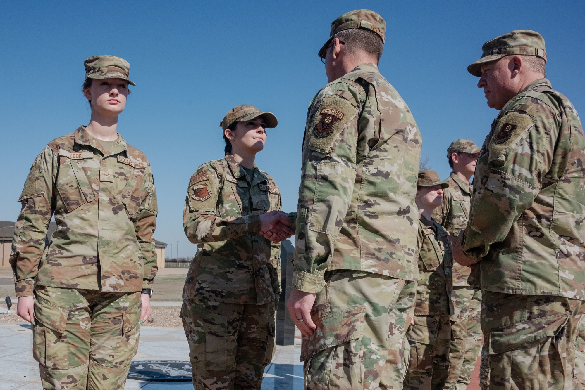 airmen shake hands outside