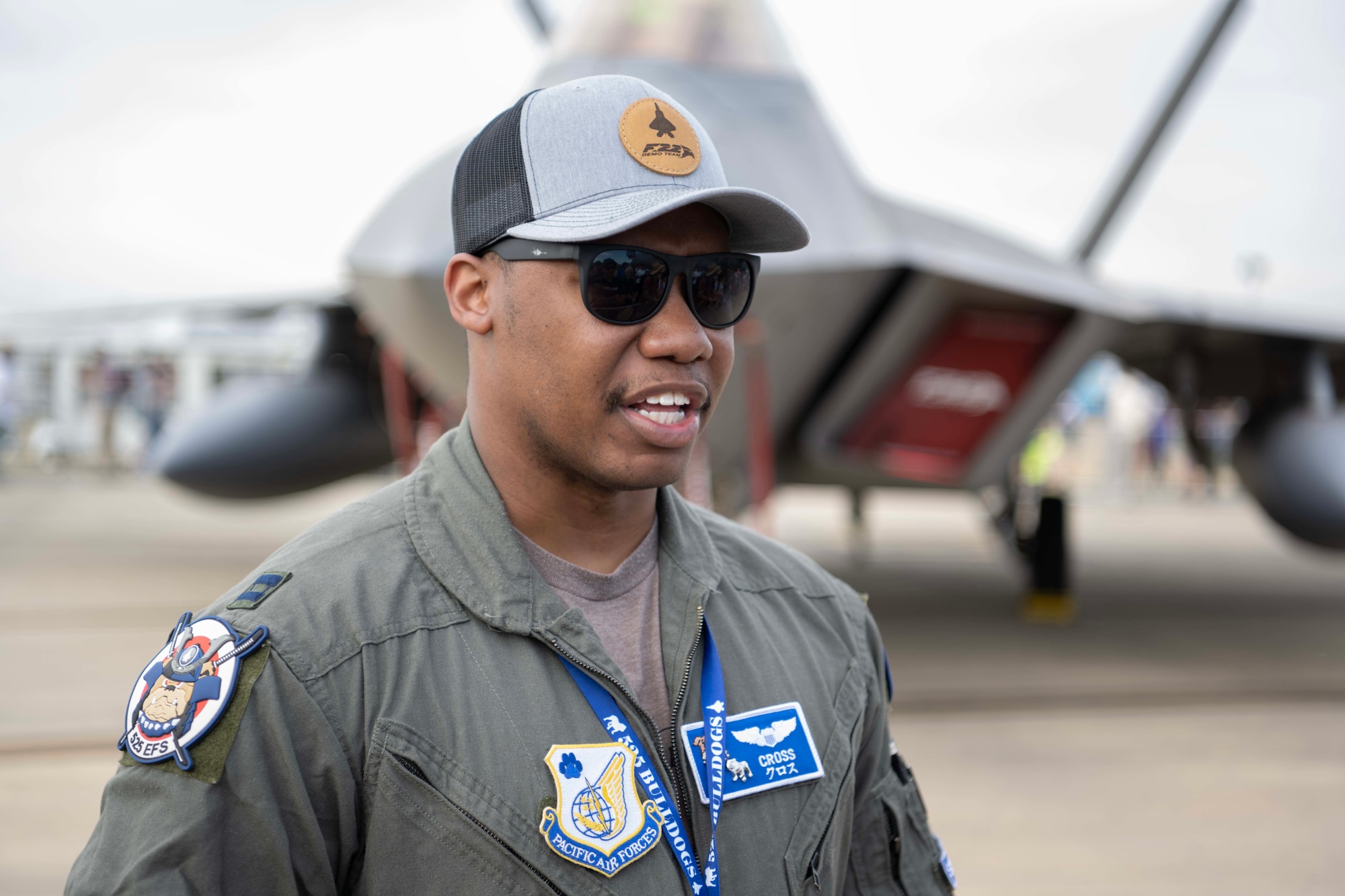 An Airman with a jet in the background