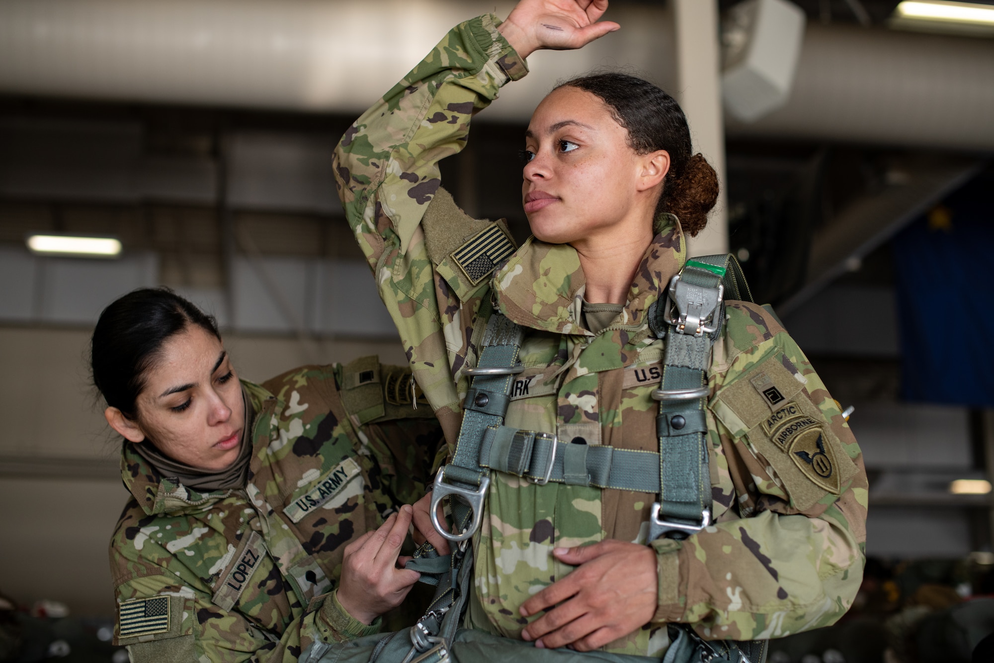 A photo of paratroopers donning parachutes