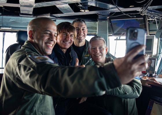 Command Master Chief Nick Wallace, left, takes a selfie with Tom Cruise, center left, Executive Officer, Capt. Gregory Nery, center right, and Commanding Officer, Capt. Dave Pollard, aboard the Nimitz-class aircraft carrier USS George H.W. Bush, during a visit to the ship, March 3, 2023. The George H.W. Bush Carrier Strike Group is on a scheduled deployment in the U.S. Naval Forces Europe area of operations, employed by U.S. Sixth Fleet to defend U.S., allied and partner interests.