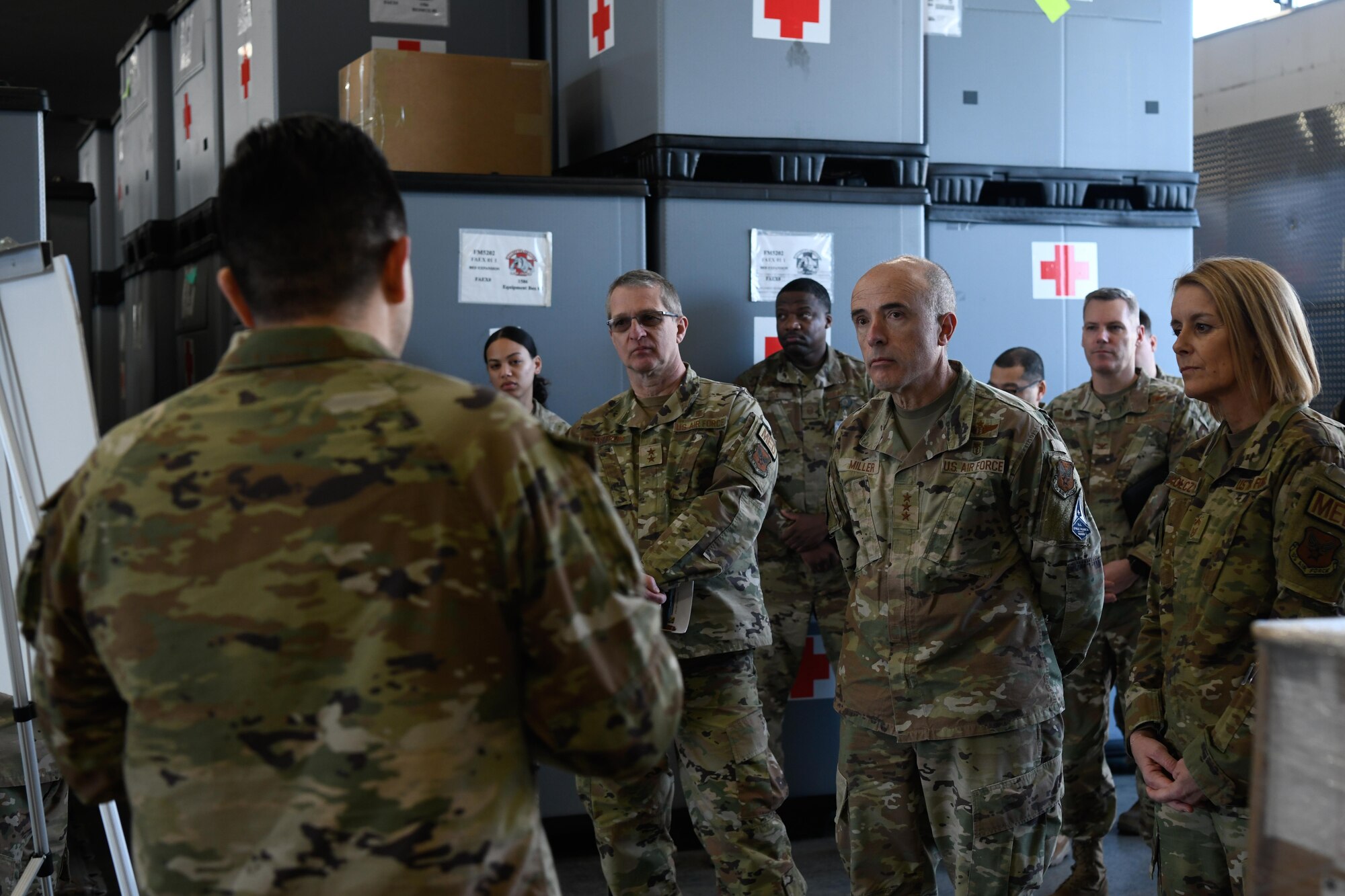 A service member briefs other service members on topic.