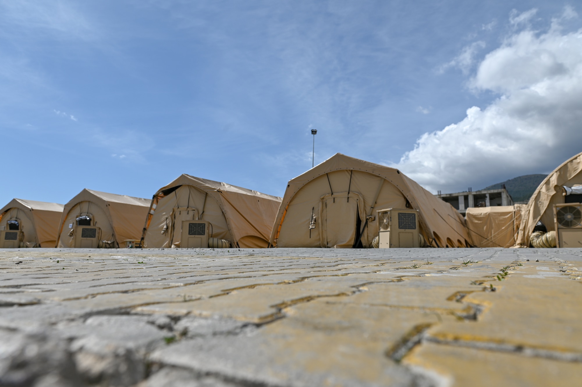 Tents in the parking lot of the damaged Mustafa Kemal University Hospital serve as a temporary field hospital in Serinyol, Hatay, Türkiye, March 7, 2023.