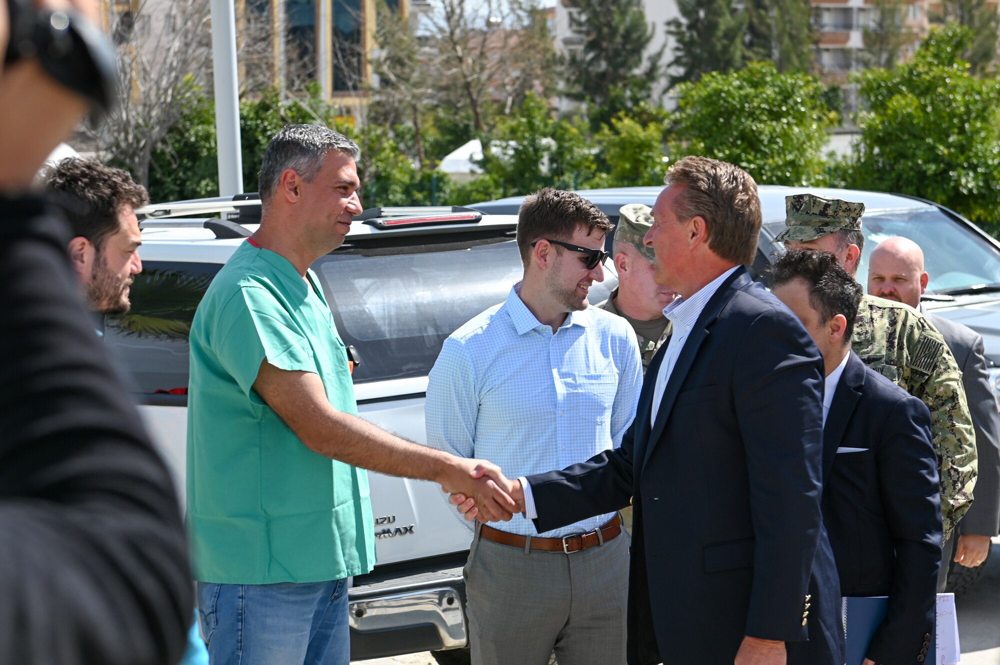 Dr. Onur Koyuncu, left, Mustafa Kemal University Hospital head physician, greets U.S. Ambassador Jeffry Flake, U.S. Ambassador to Türkiye, at the field hospital on the grounds of Mustafa Kemal University in Serinyol, Hatay, Türkiye, March 7, 2023.