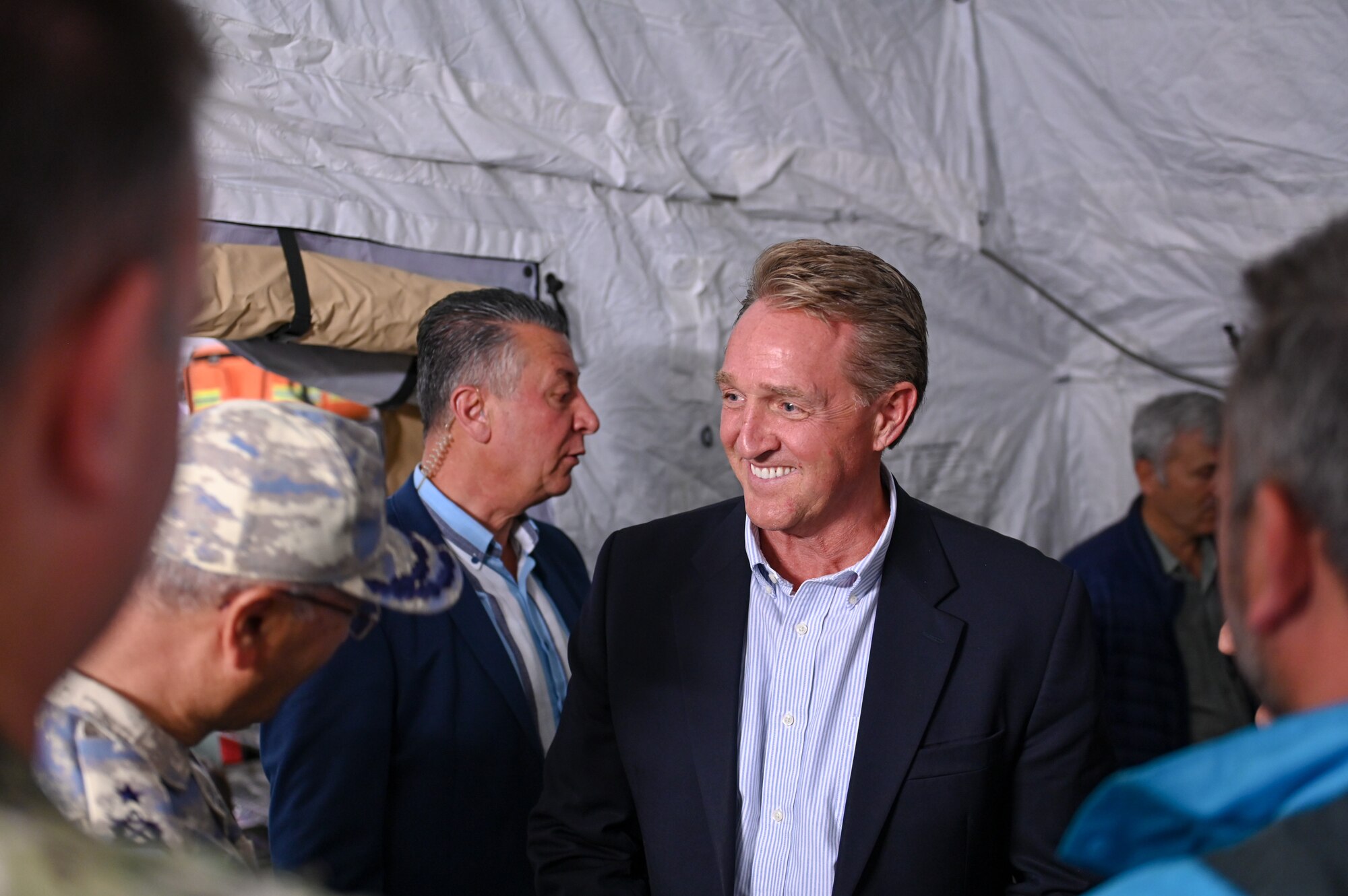 U.S. Ambassador to Türkiye Jeffry Flake greets individuals in the tents at the field hospital on the grounds of Mustafa Kemal University in Serinyol, Hatay, Türkiye, March 7, 2023.