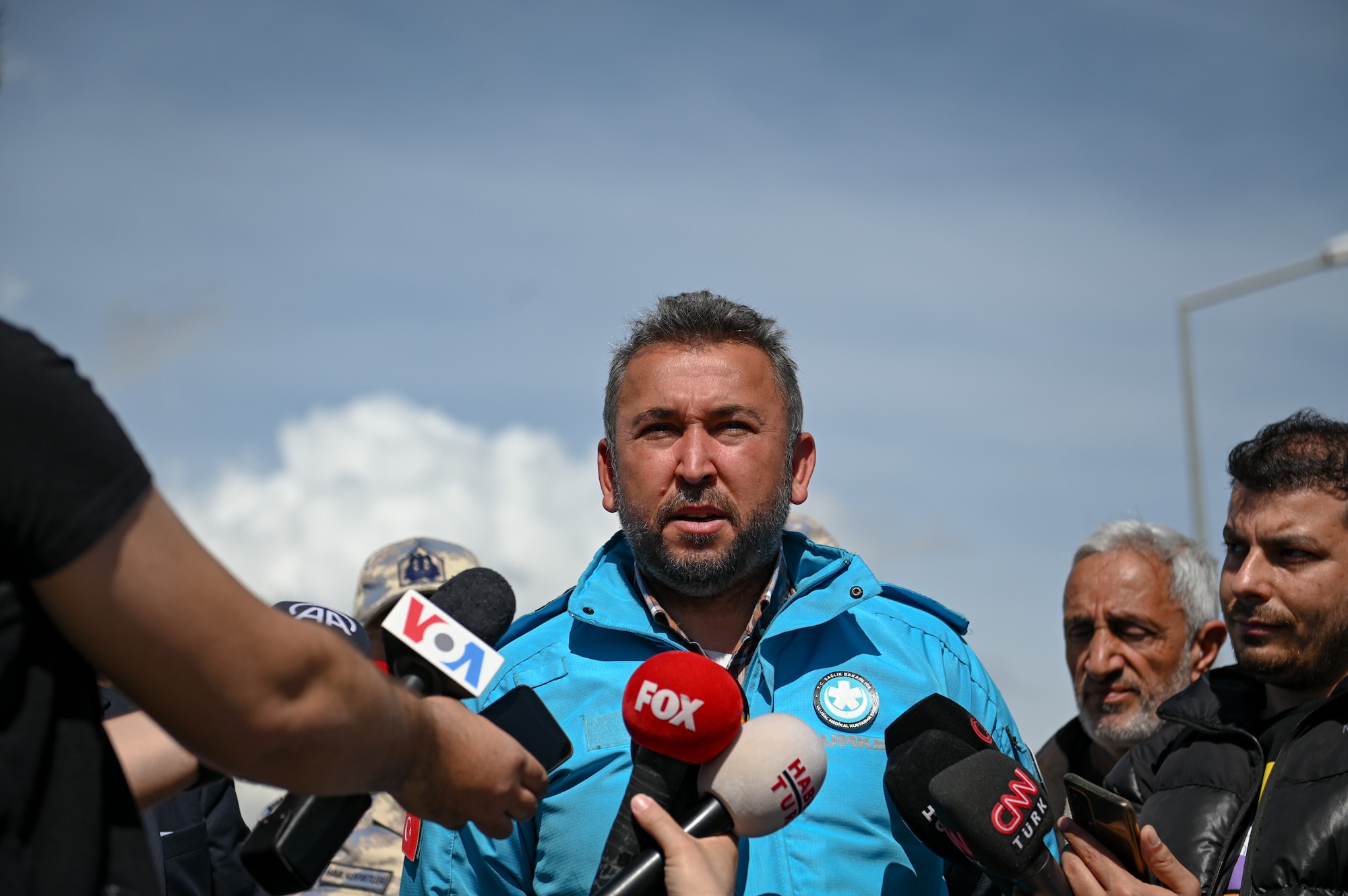 Arif Çetin, Türkiye’s Ministry of Health deputy director general of EU and Foreign Affairs, speaks to media outlets at the field hospital on the grounds of Mustafa Kemal University in Serinyol, Hatay, Türkiye, March 7, 2023.