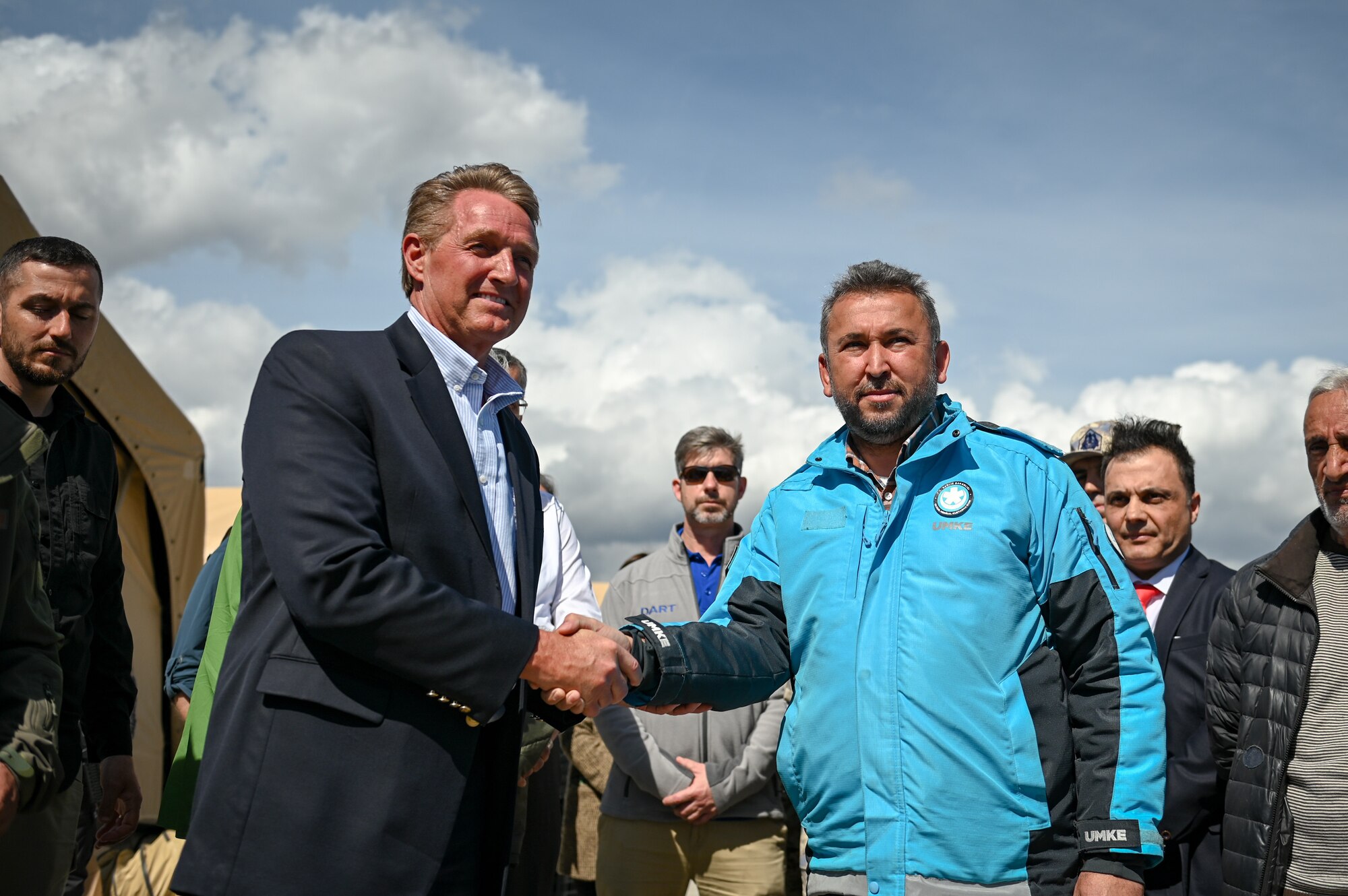 Ambassador Jeffry Flake, left, U.S. Ambassador to Türkiye, shakes hands with Arif Çetin, Türkiye’s Ministry of Health deputy director general of EU and Foreign Affairs, at the field hospital on the grounds of Mustafa Kemal University in Serinyol, Hatay, Türkiye, March 7, 2023.