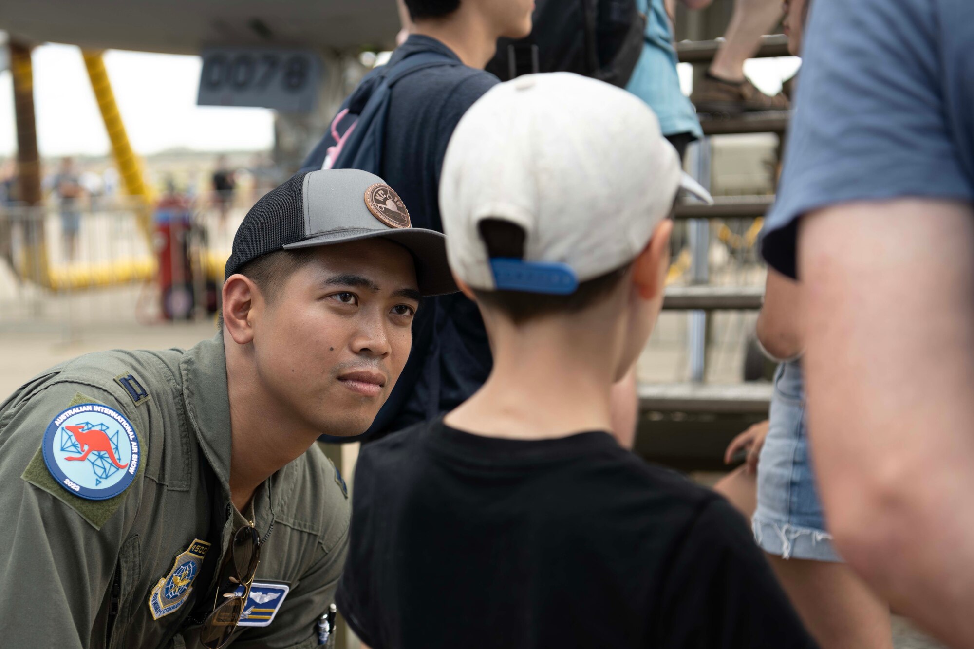 An airman talks to a child
