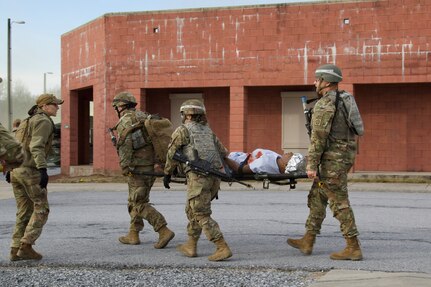 U.S. Soldiers evacuate a simulated casualty during an exercise at the Combined Arms Collective Training Facility at Fort Indiantown Gap, March 3, 2023. This exercise included responding to the scene of a mass casualty event, providing first aid and evacuating the simulated casualties to a field hospital where they received further care, all while being assessed by instructors with the Pennsylvania National Guard’s 4th Battalion, 166th Regiment Regional Training Institute (Medical Battalion Training Site). (U.S. Army National Guard photo by Maj. Travis Mueller)