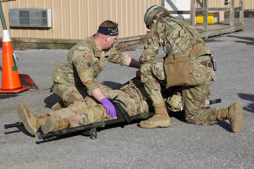U.S. Soldiers provide aid to a simulated casualty at a field hospital during an exercise at Fort Indiantown Gap, March 3, 2023. This exercise included responding to the scene of a mass casualty event, providing first aid and evacuating the simulated casualties to a field hospital where they received further care, all while being assessed by instructors with the Pennsylvania National Guard’s 4th Battalion, 166th Regiment Regional Training Institute (Medical Battalion Training Site). (U.S. Army National Guard photo by Maj. Travis Mueller)