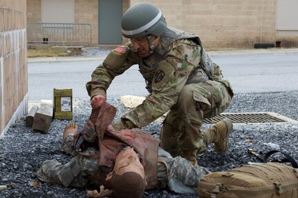 A U.S. Soldier provides first aid to a simulated casualty during an exercise at the Combined Arms Collective Training Facility at Fort Indiantown Gap, March 3, 2023. This exercise included responding to the scene of a mass casualty event, providing first aid and evacuating the simulated casualties to a field hospital where they received further care, all while being assessed by instructors with the Pennsylvania National Guard’s 4th Battalion, 166th Regiment Regional Training Institute (Medical Battalion Training Site). (U.S. Army National Guard photo by Maj. Travis Mueller)