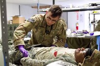 A U.S. Soldier provides aid to a simulated casualty at a field hospital during an exercise at Fort Indiantown Gap, March 3, 2023. This exercise included responding to the scene of a mass casualty event, providing first aid and evacuating the simulated casualties to a field hospital where they received further care, all while being assessed by instructors with the Pennsylvania National Guard’s 4th Battalion, 166th Regiment Regional Training Institute (Medical Battalion Training Site). (U.S. Army National Guard photo by Maj. Travis Mueller)