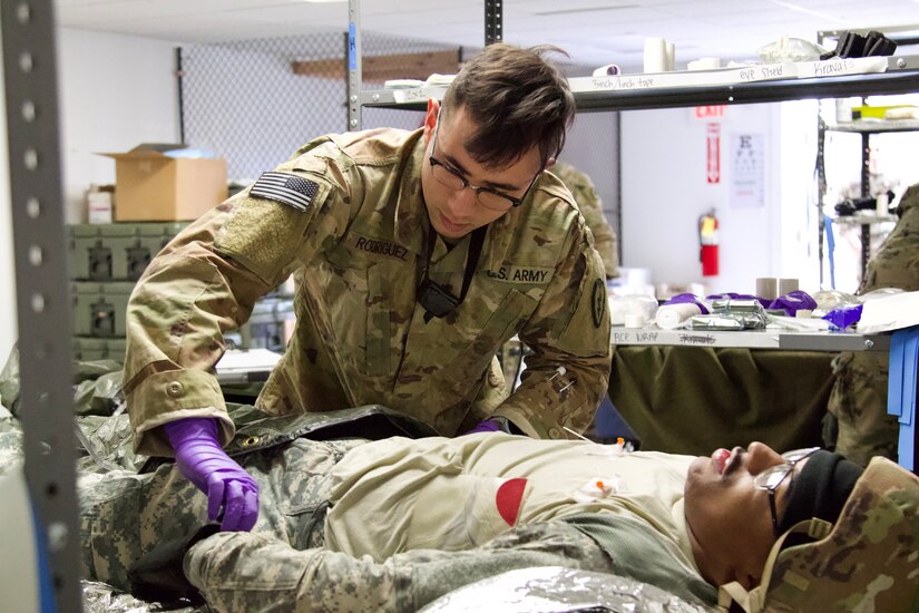 A U.S. Soldier provides aid to a simulated casualty at a field hospital during an exercise at Fort Indiantown Gap, March 3, 2023. This exercise included responding to the scene of a mass casualty event, providing first aid and evacuating the simulated casualties to a field hospital where they received further care, all while being assessed by instructors with the Pennsylvania National Guard’s 4th Battalion, 166th Regiment Regional Training Institute (Medical Battalion Training Site). (U.S. Army National Guard photo by Maj. Travis Mueller)