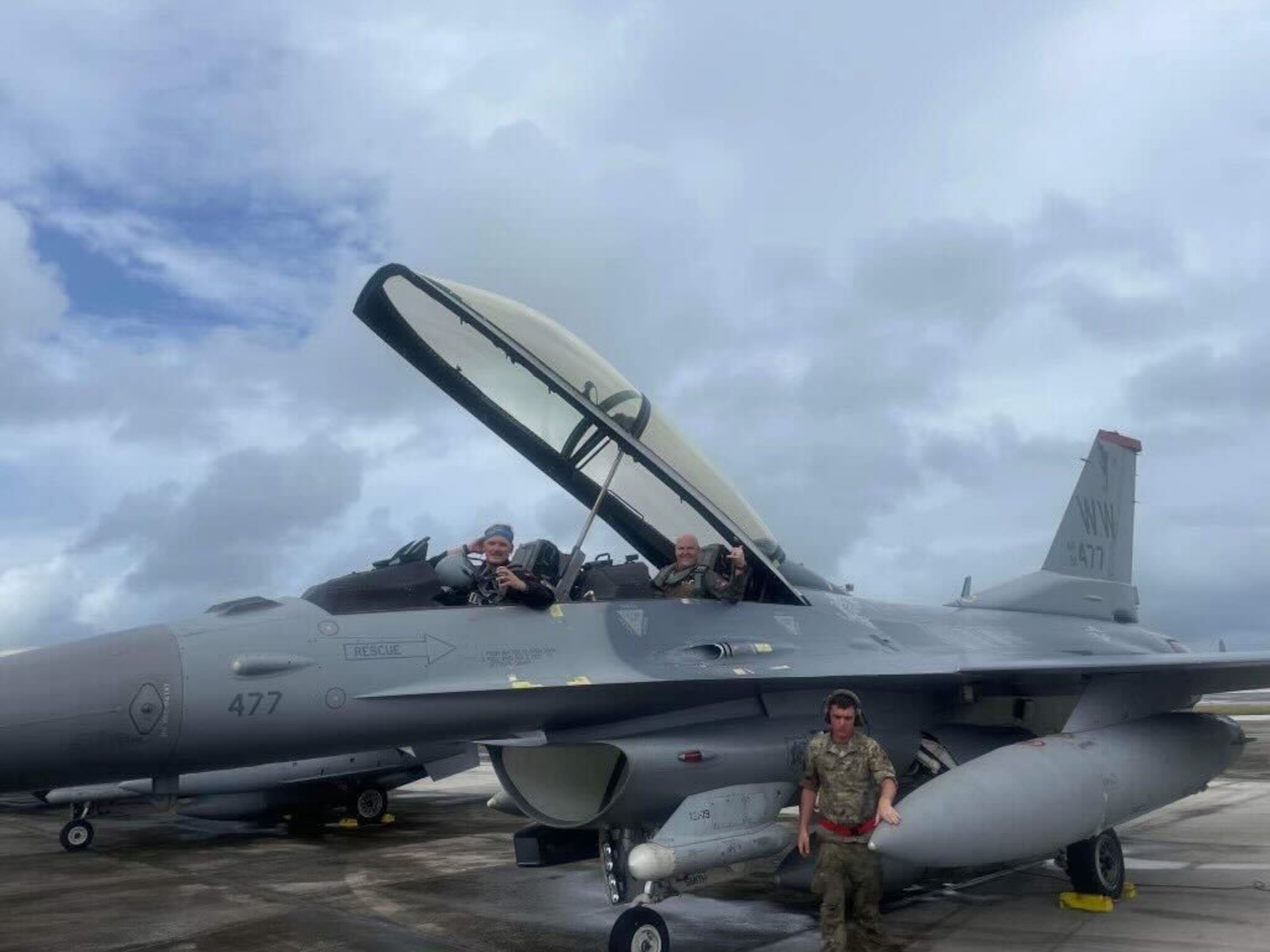 1st Lt. Matthew "Shoots" Oliver, 13th Fighter Squadron, Misawa Air base, Japan, F-16 Fighting Falcon pilot, front seat, and Maj. Michael "Deuce" Oliver, 3rd Wing, Joint Base Elmendorf-Richardson, Alaska, F-22 pilot, back seat, prepare to fly in a F-16D model aircraft at Andersen Air Force Base, Guam. (Courtesy Photo)