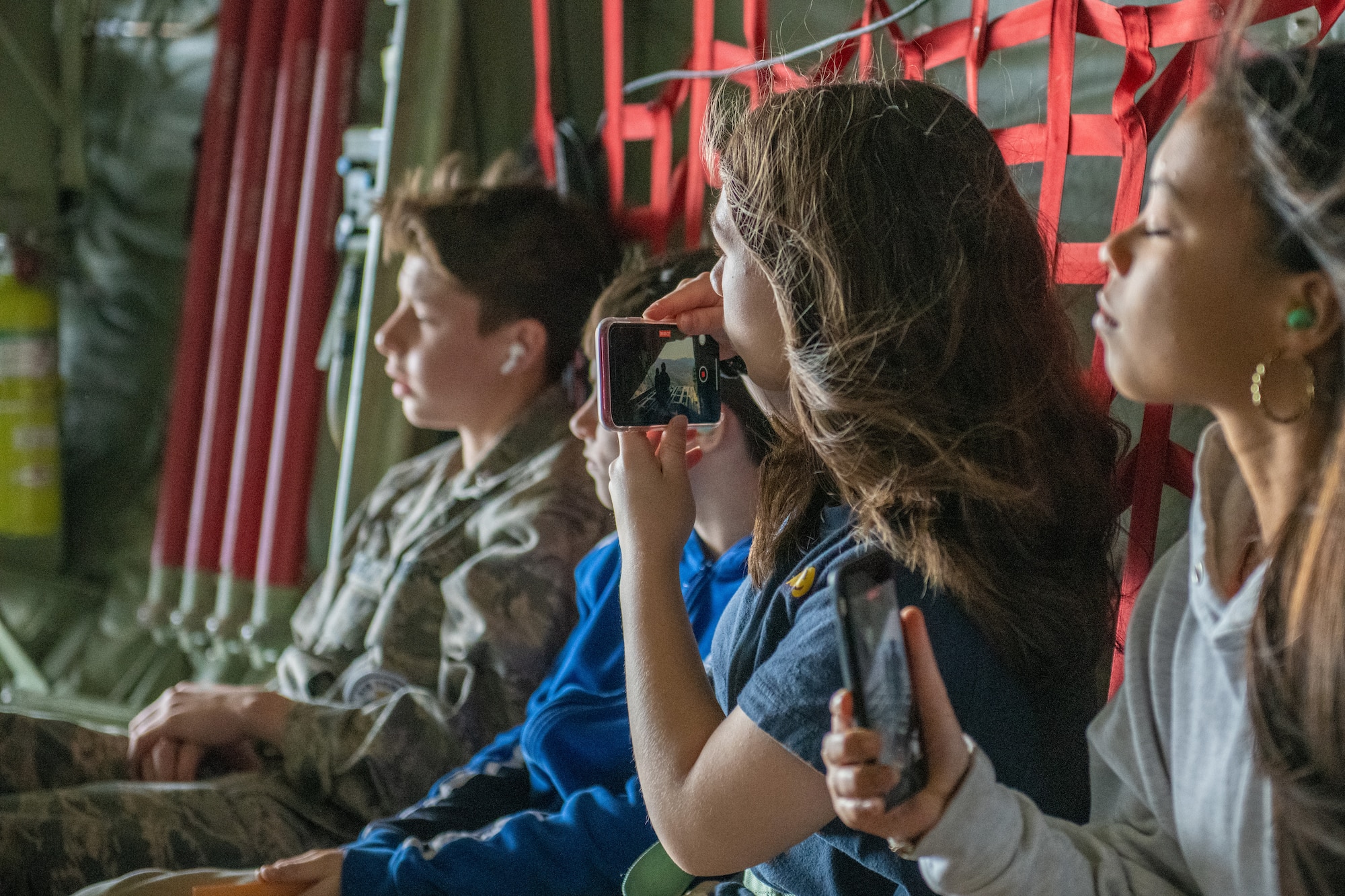 Students look out of the open ramp of a C-130J Super Hercules
