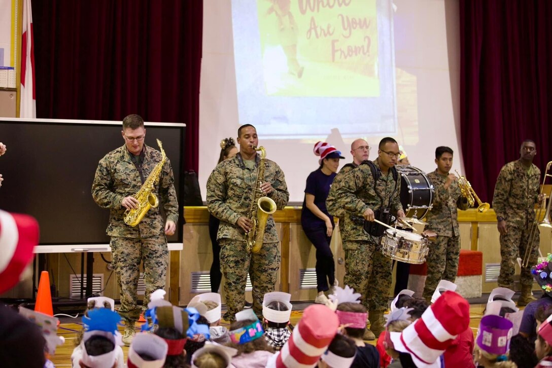 The U.S. Marine Corps III Marine Expeditionary Force Brass Band performed for the "Read Across America" assembly at Kinser Elementary School aboard Camp Kinser in Okinawa, Japan. The Brass Band delivered a high energy performance as the students paraded into the gym for the event.