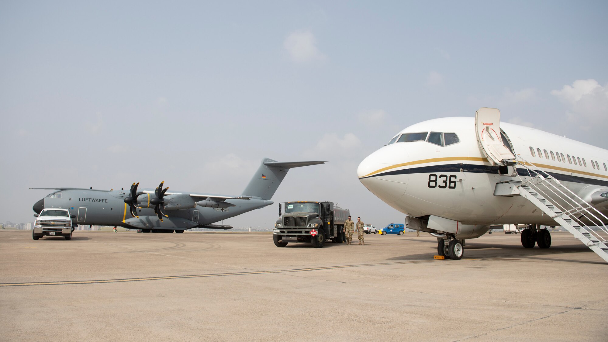 U.S. Air Force petroleum, oil and lubricant Airmen assigned to the 39th Logistics Readiness Squadron conduct flightline refueling, while a German Air Force A400M military transport aircraft and a U.S. Navy C-40 Clipper logistics aircraft standby for cargo and personnel transport in support of Turkish government earthquake relief operations March 3, 2023, at Incirlik Air Base, Türkiye. U.S. military organizations are working with interagency colleagues to harness the unique capabilities available to assist those affected by the earthquakes. The U.S. military’s role during these relief missions is to rapidly respond to this natural disaster with critical support capabilities and life-saving equipment, transporting assistance for aid areas the government of Türkiye deems most necessary. (U.S. Air Force photo by Staff Sgt. Peter Reft)